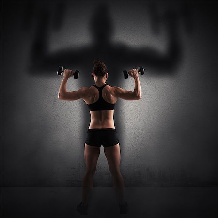 simsearch:400-08505882,k - Muscular woman looks at her big shadow Stock Photo - Budget Royalty-Free & Subscription, Code: 400-08503347