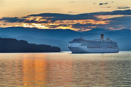 simsearch:400-06067620,k - Sunrise in the greek archipelago with cruise ship approaching land Stock Photo - Budget Royalty-Free & Subscription, Code: 400-08528872