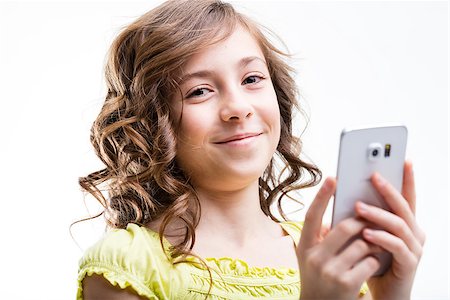 simsearch:400-08831347,k - smiling little girl using a smartphone Stock Photo - Budget Royalty-Free & Subscription, Code: 400-08529284