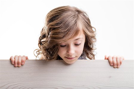 simsearch:400-08831347,k - little girl watches down from behind a wooden table Stock Photo - Budget Royalty-Free & Subscription, Code: 400-08529281