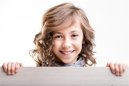 simsearch:400-08831347,k - smiling and laughing little girl from behind a wooden fence Stock Photo - Budget Royalty-Free & Subscription, Code: 400-08529282