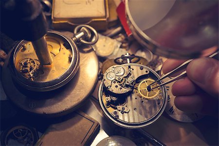relojero (hombre y mujer) - Watchmakers Craftmanship. A watch maker repairing a vintage automatic watch. Foto de stock - Super Valor sin royalties y Suscripción, Código: 400-08529565