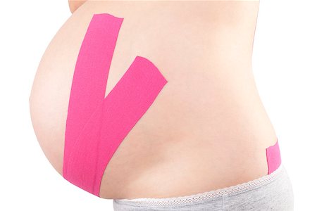 simsearch:400-08529613,k - Beautiful pregnant woman with kinesio tape. Back pain in pregnancy, alternative kinesio tape therapy. Stock Photo - Budget Royalty-Free & Subscription, Code: 400-08529606