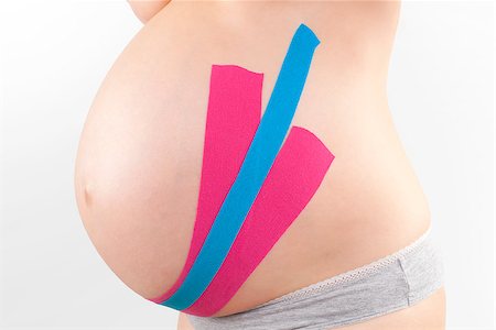 simsearch:400-08529613,k - Beautiful pregnant woman with kinesio tape. Back pain in pregnancy, alternative kinesio tape therapy. Stock Photo - Budget Royalty-Free & Subscription, Code: 400-08529607