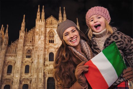simsearch:400-08864986,k - Family holidays in style. Portrait of smiling mother and daughter showing Italian flag in the front of Duomo in Milan, Italy in the evening Stock Photo - Budget Royalty-Free & Subscription, Code: 400-08530929