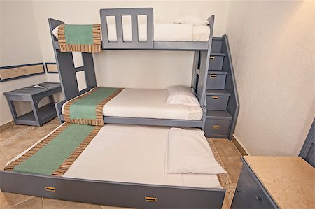Space saving bunk beds in family bedroom storage concept idea with steps Fotografie stock - Microstock e Abbonamento, Codice: 400-08531480