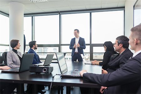 Successful team leader and business owner  leading in-house business meeting, explaining business plans to his employees. Business and entrepreneurship concept. Stock Photo - Budget Royalty-Free & Subscription, Code: 400-08532108