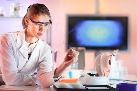 Life science researcher working in laboratory. Portrait of a confident female health care professional in his working environment writing structural chemical formula on a glass board. Stock Photo - Budget Royalty-Free & Subscription, Code: 400-08532101
