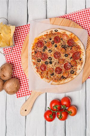 simsearch:400-07893141,k - Italian pizza served on wooden table, close-up. Photographie de stock - Aubaine LD & Abonnement, Code: 400-08532309