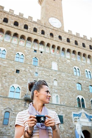 simsearch:400-08530001,k - It's time to tick off must-see Florence treasures of a bucket list. Young woman tourist with digital photo camera looking aside in the front of Palazzo Vecchio in Florence, Italy Stockbilder - Microstock & Abonnement, Bildnummer: 400-08532480