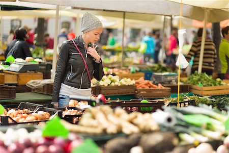 Woman buying fruits and vegetables at local food market. Market stall with variety of organic vegetable. Stock Photo - Budget Royalty-Free & Subscription, Code: 400-08533011