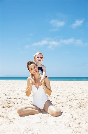 simsearch:400-06639191,k - Family fun on white sand. Portrait of happy mother and girl in swimsuits at sandy beach on a sunny day Stock Photo - Budget Royalty-Free & Subscription, Code: 400-08533639