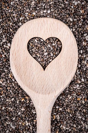 salvia hispanica - Cooking wooden spoon with heart shape cutted on chia seeds background. Photographie de stock - Aubaine LD & Abonnement, Code: 400-08533805