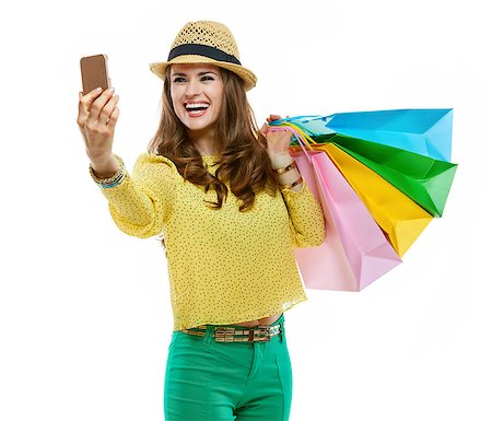 simsearch:400-09018938,k - Colourful shopping vibes. Portraits of happy brunette woman in hat and bright clothes with shopping bags taking selfie Photographie de stock - Aubaine LD & Abonnement, Code: 400-08533915