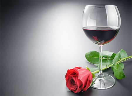 Glass of red wine and red rose flower arranged with some space on neutral gray gradient background. Stock Photo - Budget Royalty-Free & Subscription, Code: 400-08555254