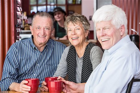 Three happy friends in a coffee house Stock Photo - Budget Royalty-Free & Subscription, Code: 400-08555835