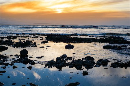 simsearch:400-08370946,k - reflections at rocky beach near ballybunion on the wild atlantic way ireland with a beautiful yellow sunset Photographie de stock - Aubaine LD & Abonnement, Code: 400-08555930