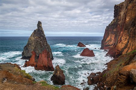 simsearch:400-08735364,k - Volcanic rocks and dangerous shores of Atlantoc ocean. Madeira island rocky coast, Portugal. Fotografie stock - Microstock e Abbonamento, Codice: 400-08556220