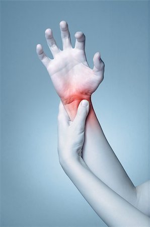 rheumatoid arthritis - A young woman massaging her painful wrist Stock Photo - Budget Royalty-Free & Subscription, Code: 400-08552526