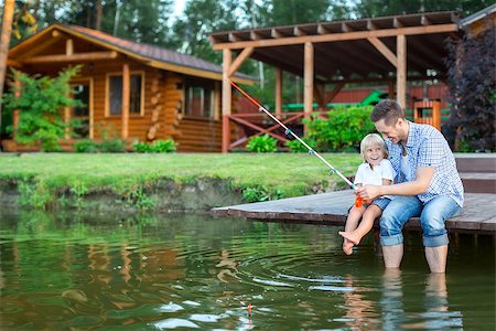father and son fishing dock lake - Father and son fishing outdoors Stock Photo - Budget Royalty-Free & Subscription, Code: 400-08552826