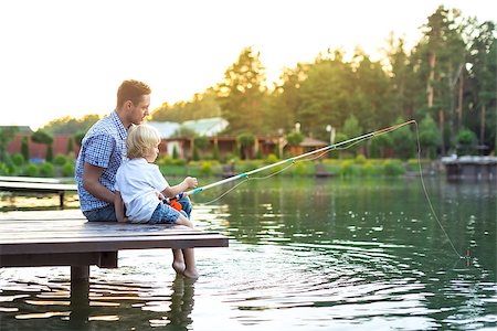 father and son fishing dock lake - Father and son fishing on the lake Stock Photo - Budget Royalty-Free & Subscription, Code: 400-08552827