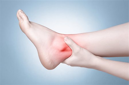 simsearch:400-08318516,k - A young woman massaging her painful ankle Stockbilder - Microstock & Abonnement, Bildnummer: 400-08553514