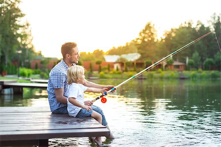 father and son fishing dock lake - Dad and son fishing outdoors Stock Photo - Budget Royalty-Free & Subscription, Code: 400-08553921