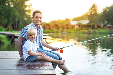 father and son fishing dock lake - Smiling dad and son fishing outdoors Stock Photo - Budget Royalty-Free & Subscription, Code: 400-08553922