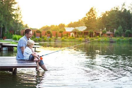 father and son fishing dock lake - Dad and son fishing on lake Stock Photo - Budget Royalty-Free & Subscription, Code: 400-08553923