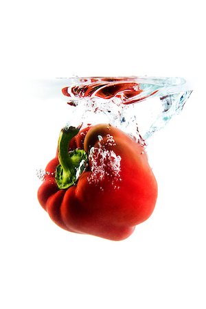 raulmellado (artist) - red pepper on white background falling and splashing water, giving a unique feeling of freshness and vitality Foto de stock - Royalty-Free Super Valor e Assinatura, Número: 400-08574033