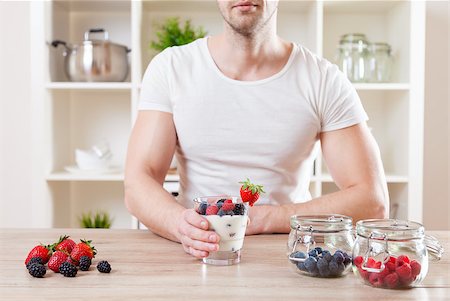 simsearch:400-04922932,k - Healthy eating concept. Closeup on man with delicious yoghurt with fresh berries Stock Photo - Budget Royalty-Free & Subscription, Code: 400-08574660