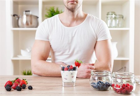 simsearch:400-04922932,k - Healthy eating concept. Closeup on man with delicious yoghurt with fresh berries Stock Photo - Budget Royalty-Free & Subscription, Code: 400-08574661