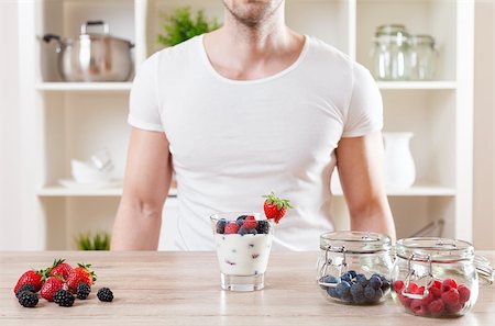 simsearch:400-04922932,k - Healthy eating concept. Closeup on man with delicious yoghurt with fresh berries Stock Photo - Budget Royalty-Free & Subscription, Code: 400-08574662