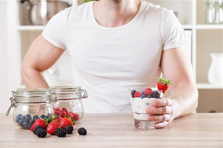 simsearch:400-04922932,k - Healthy eating concept. Closeup on man with delicious yoghurt with fresh berries Stock Photo - Budget Royalty-Free & Subscription, Code: 400-08574663
