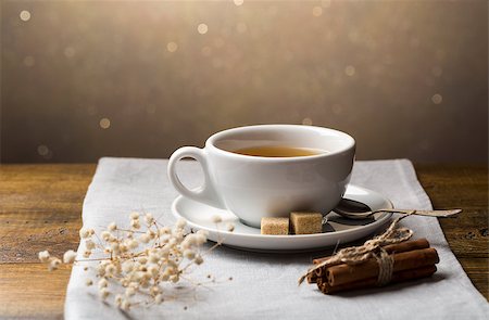 A set of tea cups with saucer and cinnamon sticks on light grey napkin Stock Photo - Budget Royalty-Free & Subscription, Code: 400-08574759