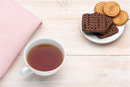 simsearch:400-08338397,k - Cup of tea and various cookies on bright wooden background Photographie de stock - Aubaine LD & Abonnement, Code: 400-08574753
