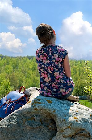 Girl sits on a stone hill and looks into the distance Stockbilder - Microstock & Abonnement, Bildnummer: 400-08575181