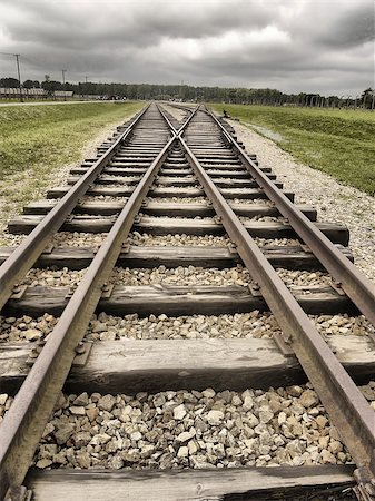 railing steel - Wooden railway tracks leading away from the photographers perspective creating easy to read lines into the image. An intersection can be seen in the top third of the image. Stock Photo - Budget Royalty-Free & Subscription, Code: 400-08572491