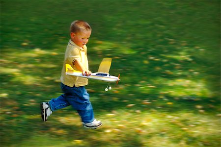 Motion photo of Boy Running with Toy Airplane Stock Photo - Budget Royalty-Free & Subscription, Code: 400-08572595