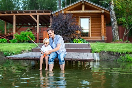 father and son fishing dock lake - Dad and son fishing outdoors Stock Photo - Budget Royalty-Free & Subscription, Code: 400-08572950
