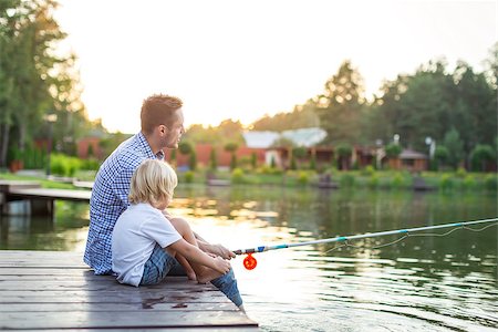 father and son fishing dock lake - Dad and son fishing outdoors Stock Photo - Budget Royalty-Free & Subscription, Code: 400-08572951