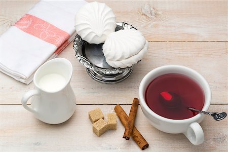 simsearch:400-08338402,k - Black tea with milk. Cane sugar and cinnamon sticks with sweet dessert on wooden table Foto de stock - Super Valor sin royalties y Suscripción, Código: 400-08573234