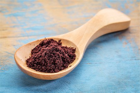 acai berry powder on a wooden spoon against blue painted grunge wood Stock Photo - Budget Royalty-Free & Subscription, Code: 400-08614343