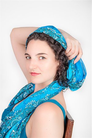 Young female model with black hair and a blue open shoulder summer dress, wearing a blue shawl over her hair. Photographie de stock - Aubaine LD & Abonnement, Code: 400-08615729