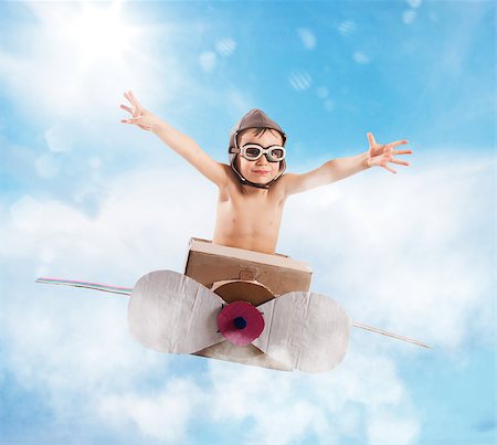 Child with cardboard airplane in the sky Stock Photo - Budget Royalty-Free & Subscription, Code: 400-08615817