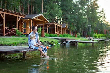 father and son fishing dock lake - Dad and son fishing on lake Stock Photo - Budget Royalty-Free & Subscription, Code: 400-08616079