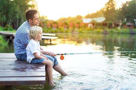 father and son fishing dock lake - Dad and son fishing on lake Stock Photo - Budget Royalty-Free & Subscription, Code: 400-08616081