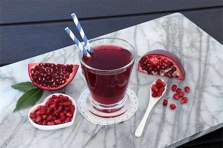 pomegranate cocktail and not people - Pomegranate juice health drink with fresh fruit on marble over wooden blue background. High in vitamins, anthocyanins, and antioxidants. Stock Photo - Budget Royalty-Free & Subscription, Code: 400-08618370