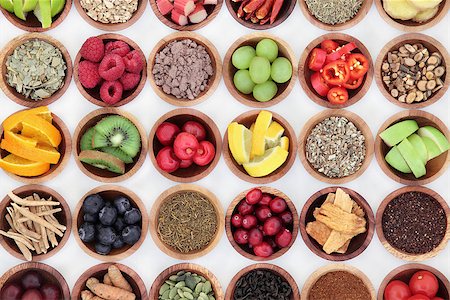 simsearch:400-08618279,k - Food selection for cold and flu remedy to boost immune system, high in vitamins, anthocyanins, antioxidants and minerals in wooden bowls over white background. Photographie de stock - Aubaine LD & Abonnement, Code: 400-08618382