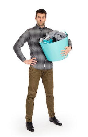 dirty clothes hamper - Full length portrait of a young man holding a laundry basket isolated on white background Foto de stock - Super Valor sin royalties y Suscripción, Código: 400-08619244